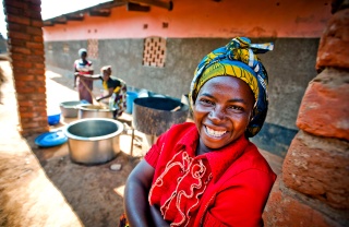 A volunteer cook in Zambia smiles