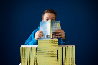 A supporter enjoys reading the Shed that Fed