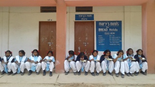 School girls in India enjoying their lunch at school. 