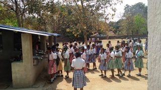Children waiting to receive their school meal in India.