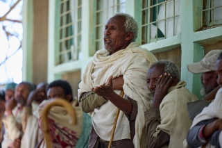 Image of Beyne Bsrat standing up to speak amongst the crowd which had gathered.