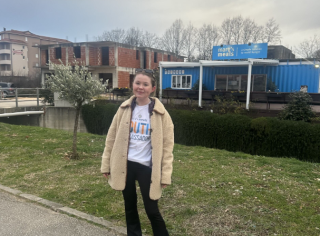 Photo of Emma in front of the Blue Container.